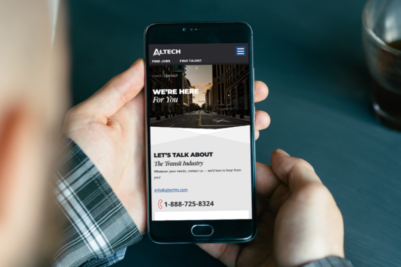A man uses a smartphone to display Altech’s new website.