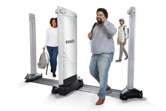Three travelers walk through Evolv secure technology.
