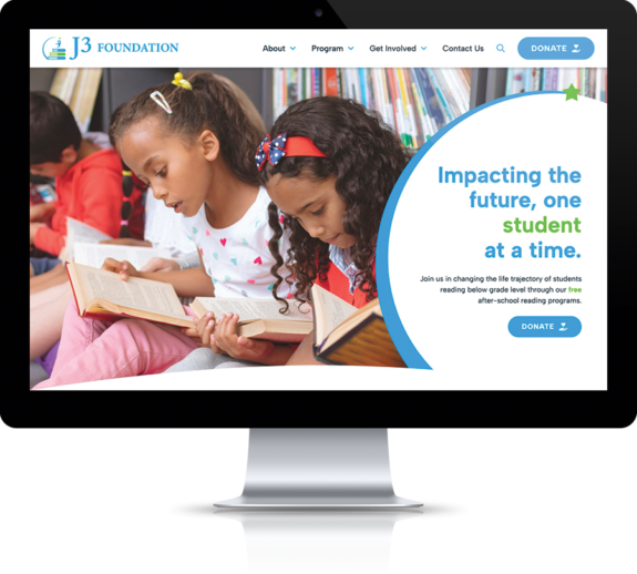The new J3 Foundation website is shown on a desktop computer and features young students reading.