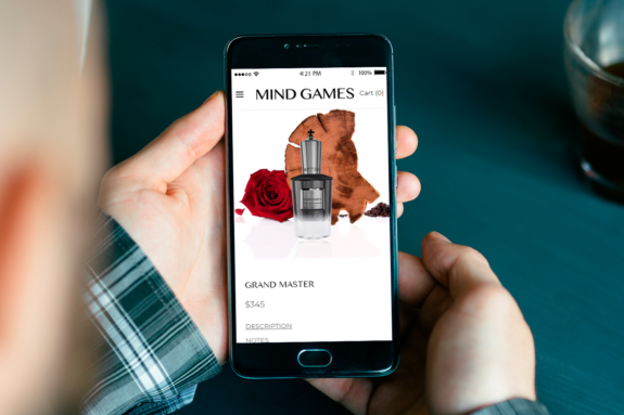 A man browses the GRAND MASTER while on the new website for MIND GAMES on a smartphone.