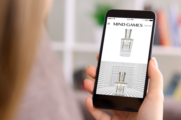 A woman shops the new MIND GAMES website on her smartphone.