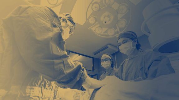 Surgeons operate on a patient.